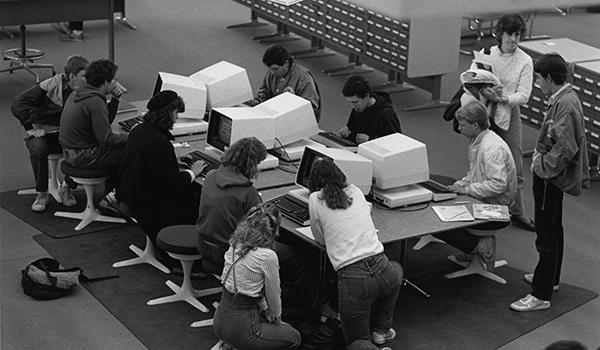 Students using the first computer catalog in the Michener Library reference area