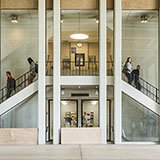 Students walk down symmetrical staircase