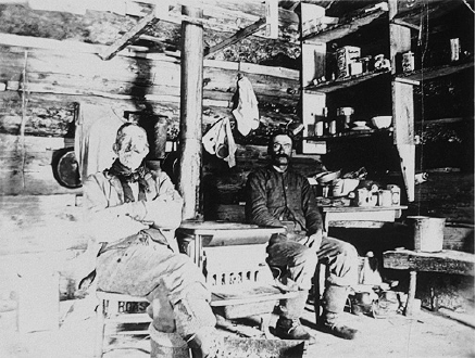 Two Miners Sitting in a Cabin
