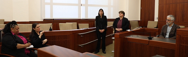 Four courtroom interpreters interpreting for a Deaf expert witness