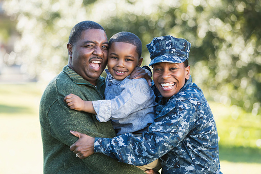 Family picture with male, child, and female in Navy uniform