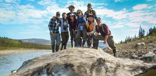 The team stops for a group photo where the river has pushed a large piece of ice onto the banks. Photo by Jimmy Dunn