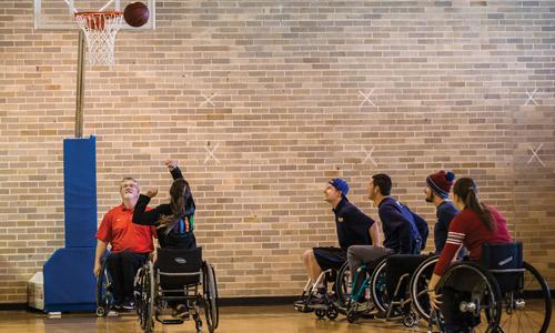 Students in Douglas’ Teaching Diverse Populations class play sports such as wheelchair tennis, basketball and rugby; seated volleyball; and boccia. Also, Douglas teaches prospective P.E. teachers and coaches how to modify sports for those with different abilities. Photography by Rob Trubia