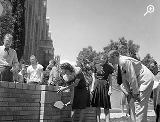 Student adding plaque on the Hi Bridge
