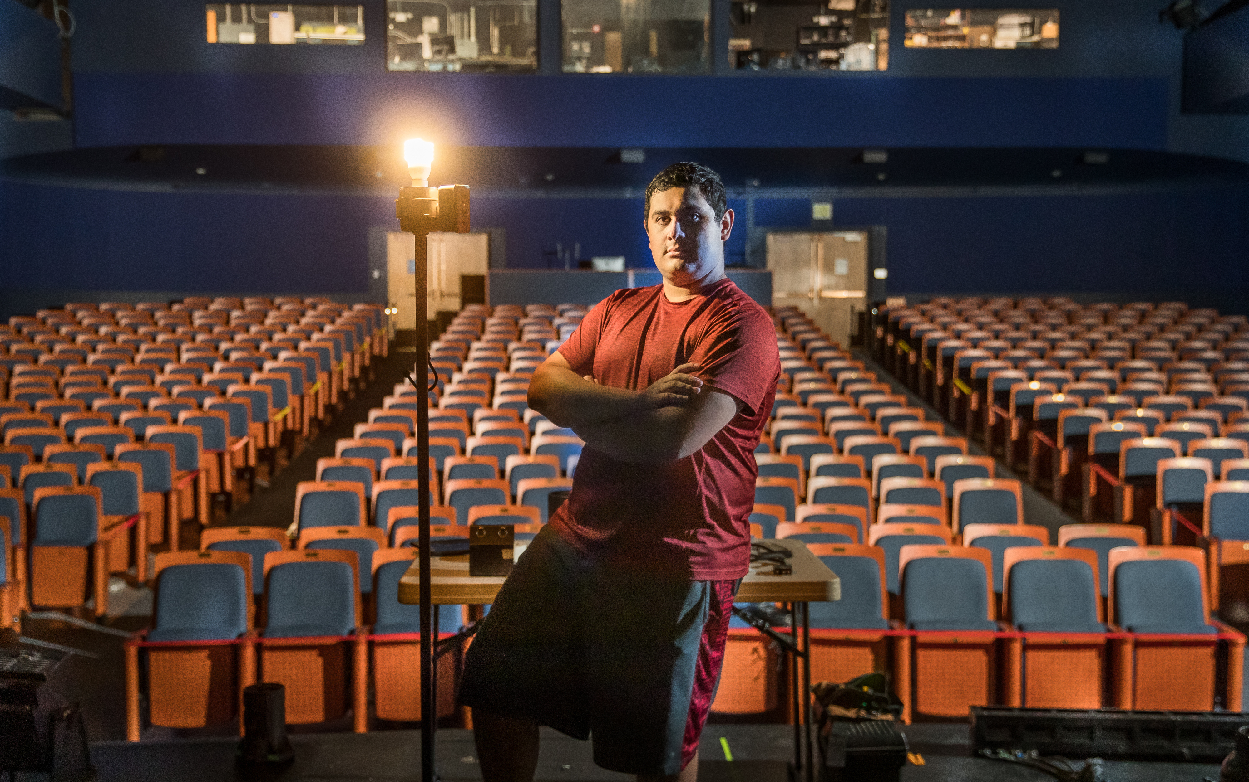 Arteaga stands on stage in front of empty theater