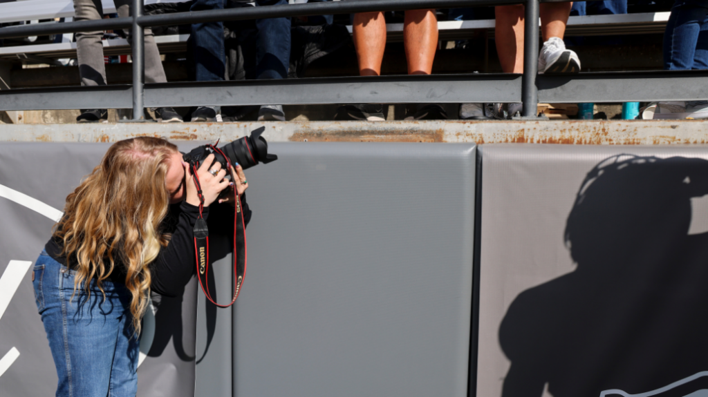 Lexie Martin taking a picture of looking to the right