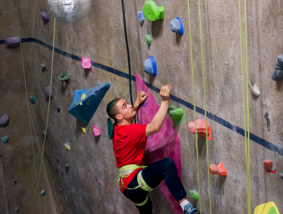 Danny Martinez, '23', climbs a recently-set route in the Rec Center