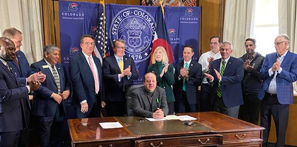 Governor Polis signing Senate Bill 56