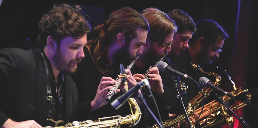 UNC performers playing saxophone and flute on stage