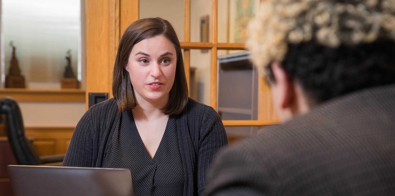 MCB students talking in the library.