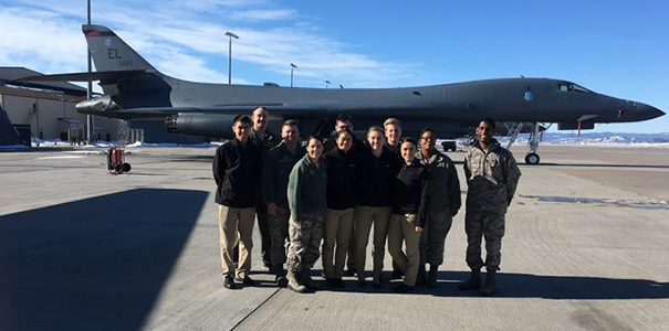 Cadets stand in front of aircraft.