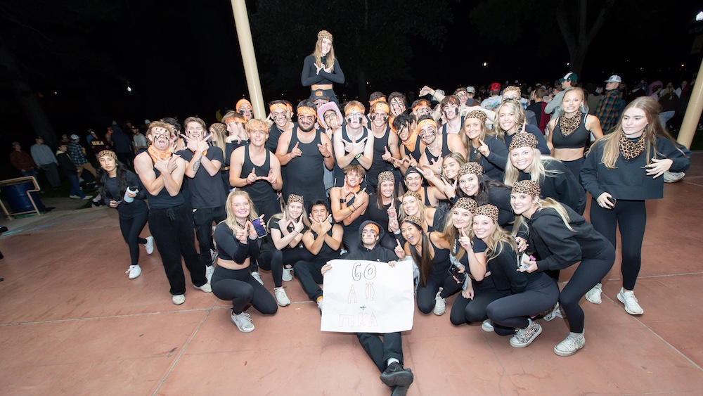 A large group of students huddled together smiling