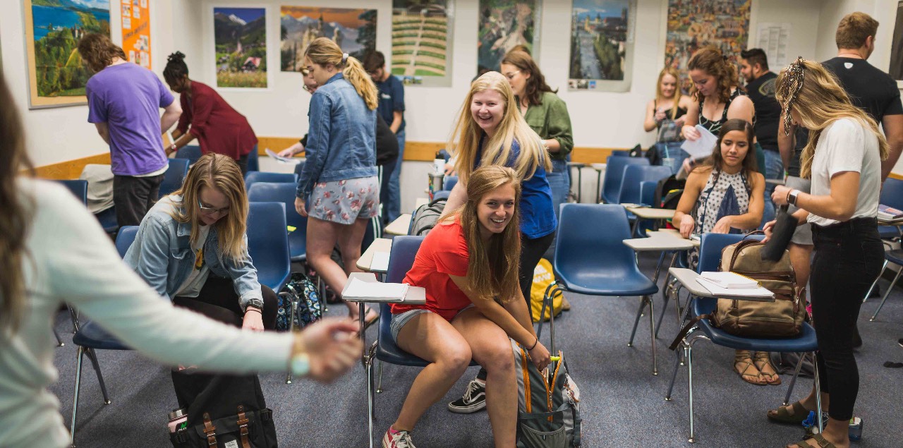 Students smile as they settle into their desks.
