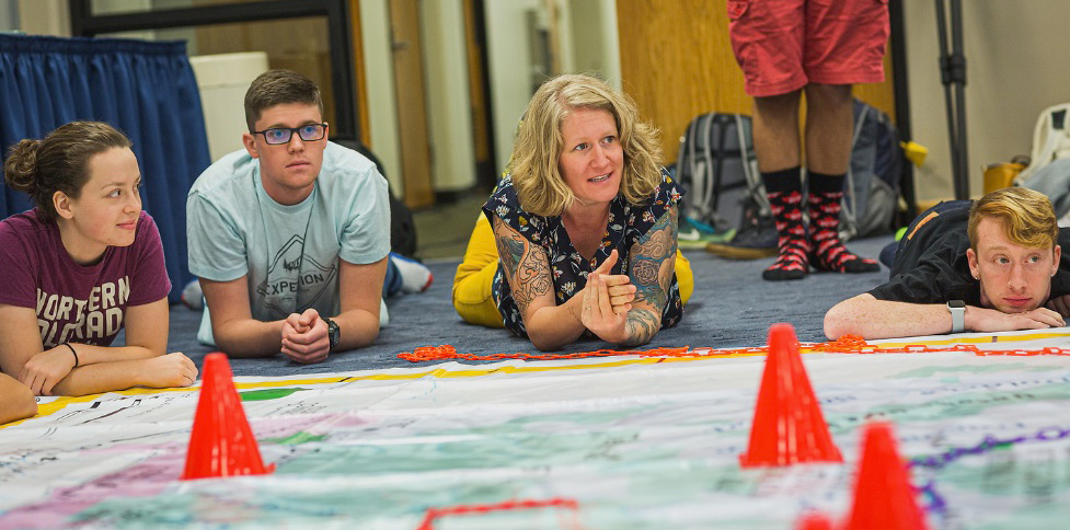 Kelly Langly Cook on the floor teaching a hands on experience