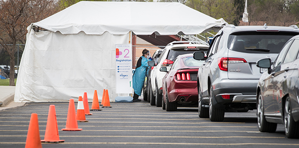 Line of cars for drive-thru testing site on campus