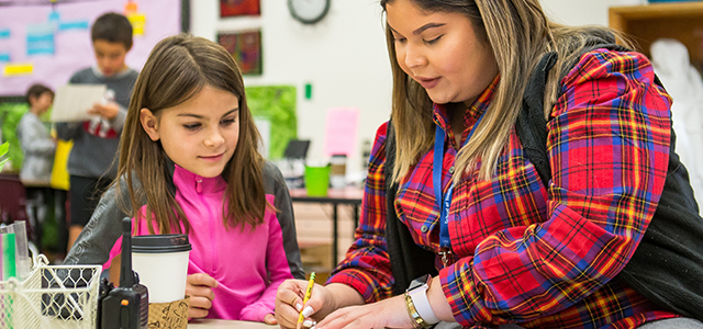 Student in UNC's CUE program working in a classroom