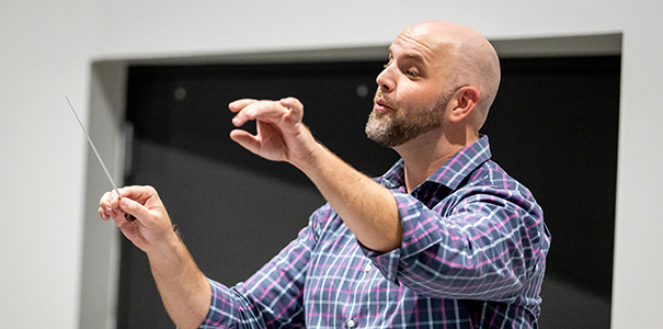 Music teacher conducting symphonic band