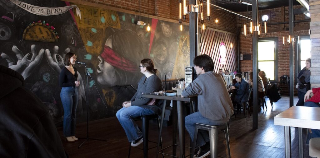 Peyton Mazza talking to the audience at Luna&rsquo;s Tacos before her performance.