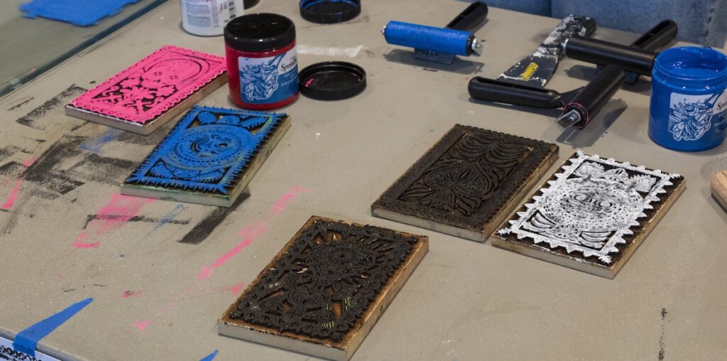 Some of the available designs one could have chosen to make a block print on a card. The designs were created by a faculty member in the visual arts department and were laser cut in the Arts Annex.