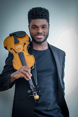 Edward Hardy standing and holding a violin