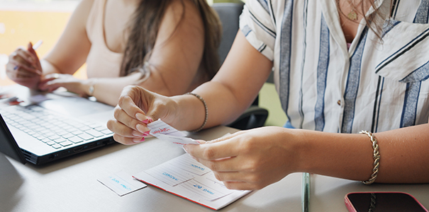 Close-up of female students reading flash cards during an adult education lesson in a classroom