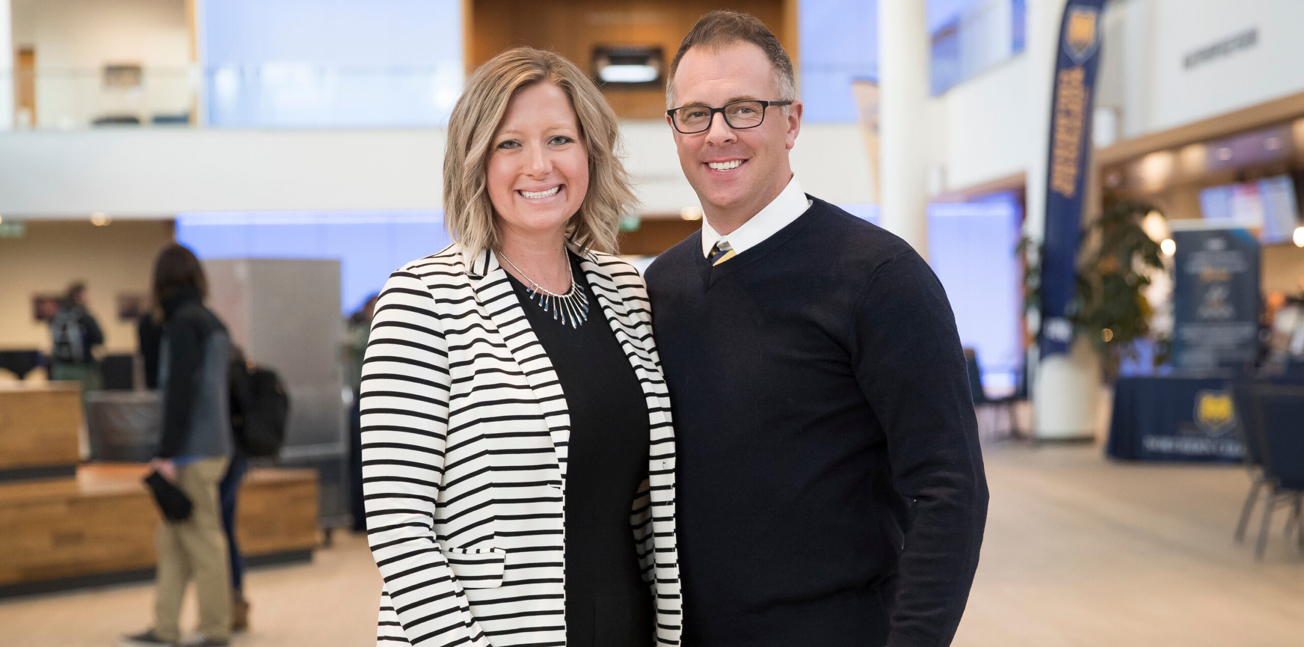 Lindsey and Casey Goodman standing next to each other, smiling