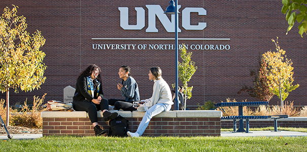 Students sitting on bench on UNC campus