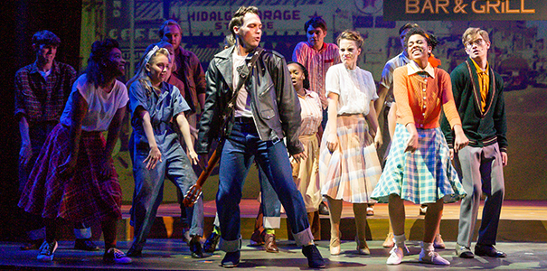 actors smiling and dancing on stage in 1950s attire in the musical All Shook Up