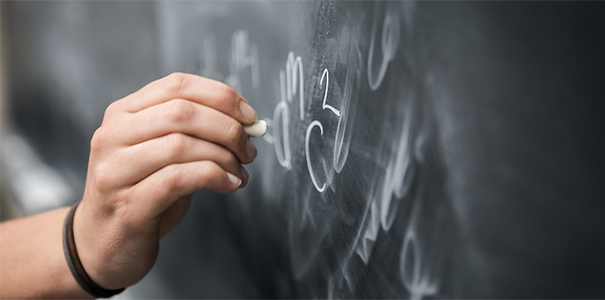 Student doing math equations on a chalkboard