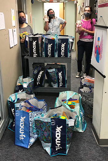 Nurses helping to deliver Murza's bags she made