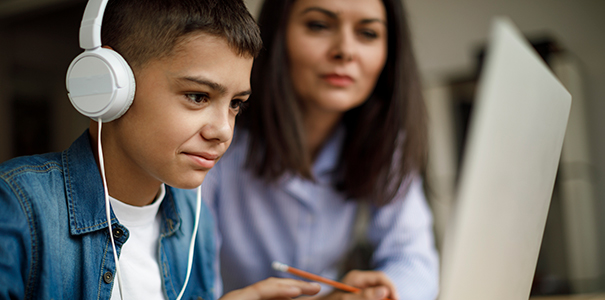 Child and parent doing remote learning, teaching