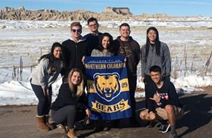 UNC AFROTC members with a UNC flag