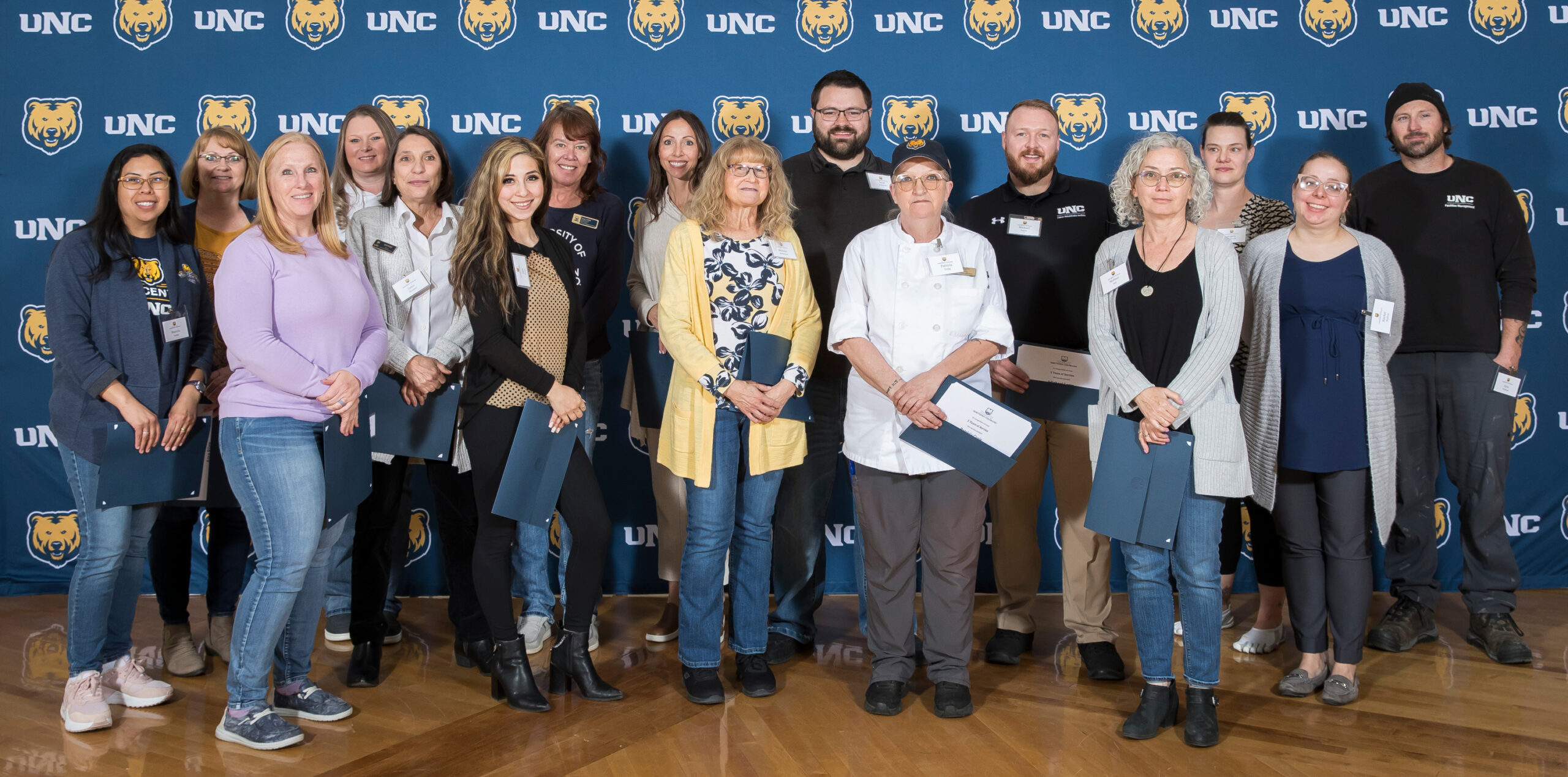 A group of UNC staff standing next to each other smiling