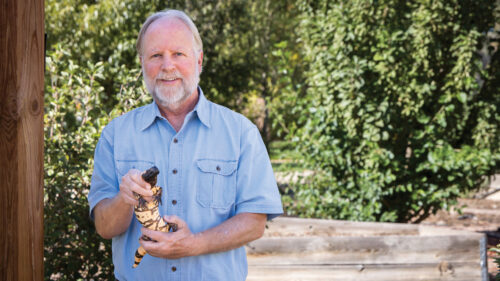 Biologist Steve Mackessy holding a Gila monster