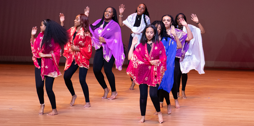 A group of women in mid dance on a stage