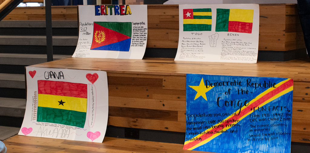 Four posters next to each other on stairs