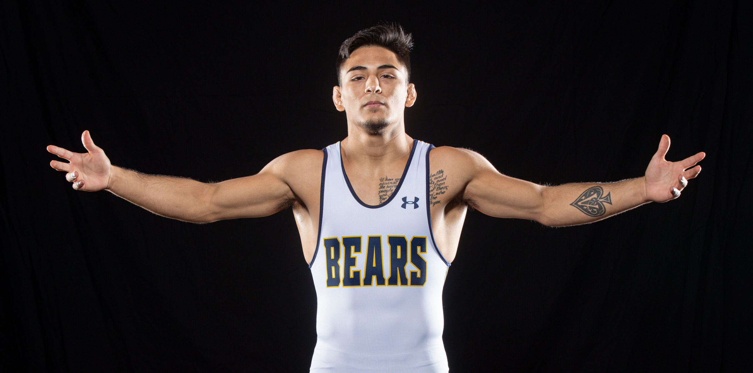 Andrew Alirez showing off his wingspan in his UNC bears wrestling uniform