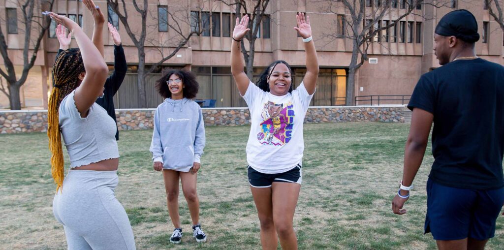 Students dancing outside during the Black Student Unit field day.