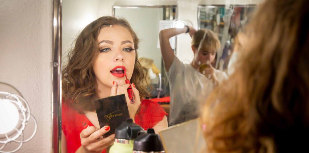 UNC student putting on lipstick