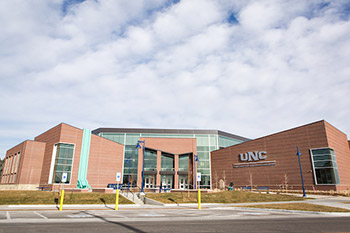 A view from the other side of the road of the Campus Commons building in the day