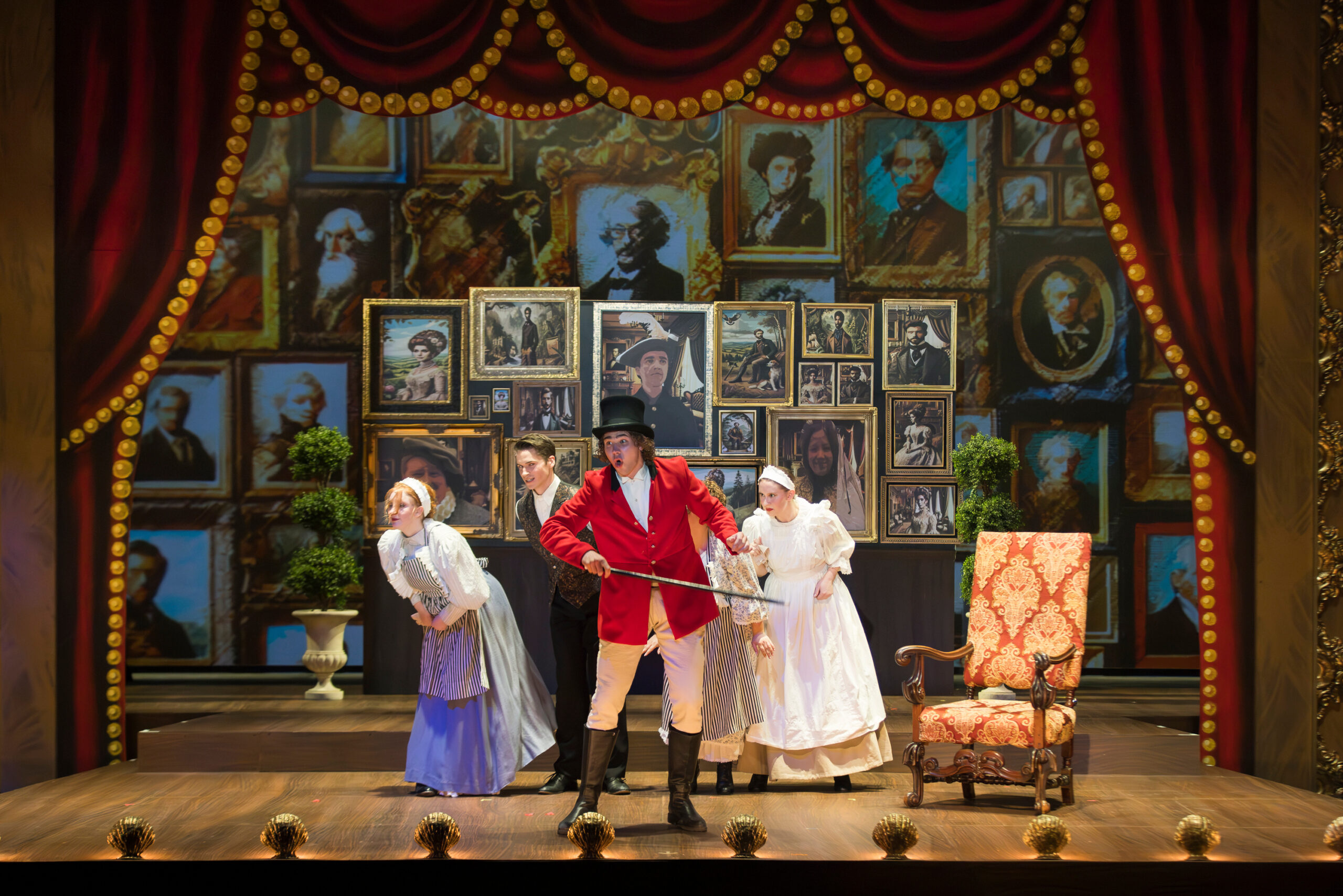Theatre stage with 4 performers in costume.