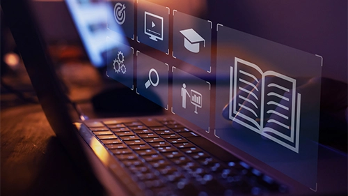 Computer with online learning icons on the screen.