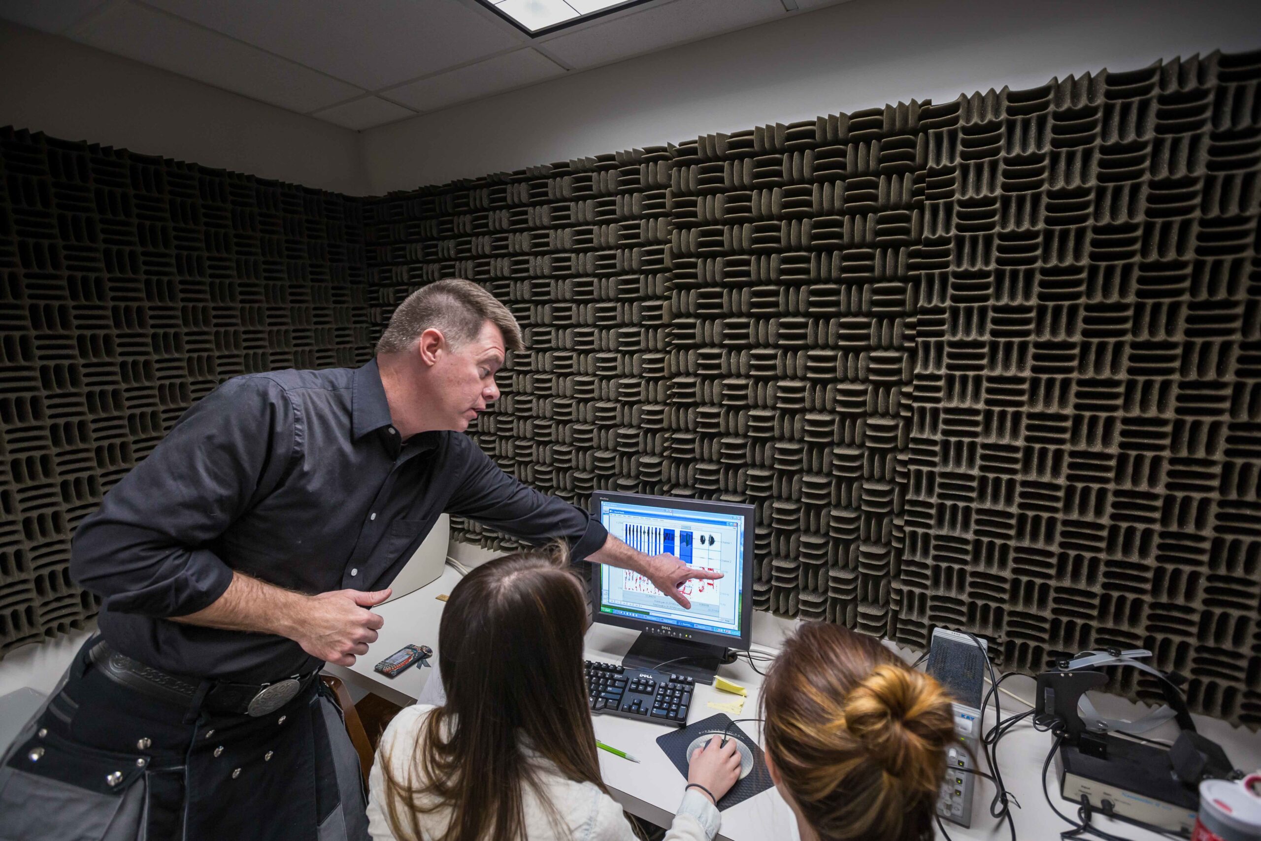 Professor teaching students in a lab.