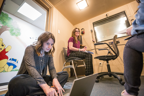 Students working in a sound booth.