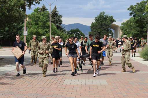 A group of Army and ROTC people running outside.