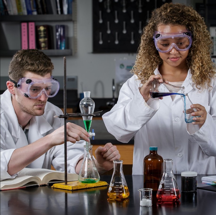 A professor and student working in a chemistry lab.
