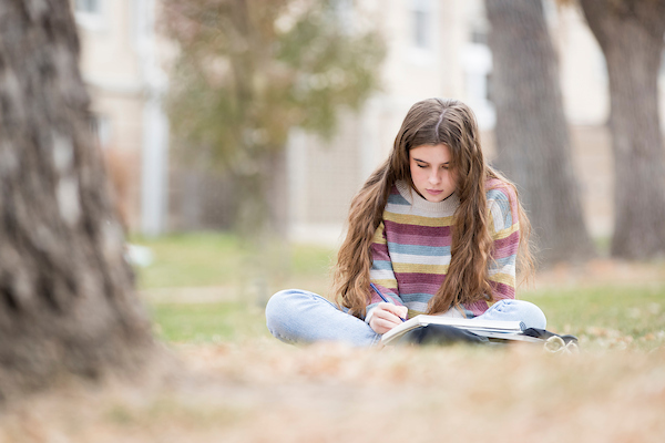 Art student drawing outside.