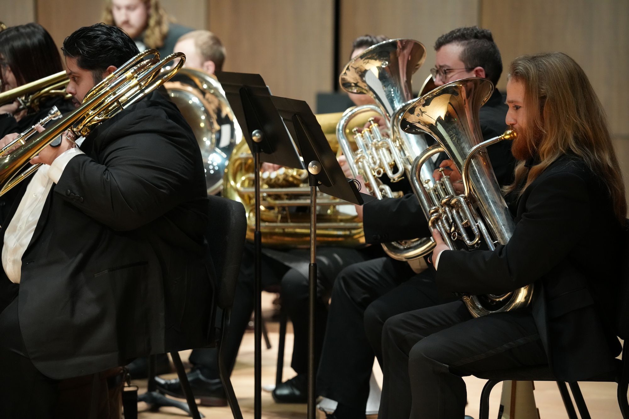 Students playing trombone, tuba, and euphonium.