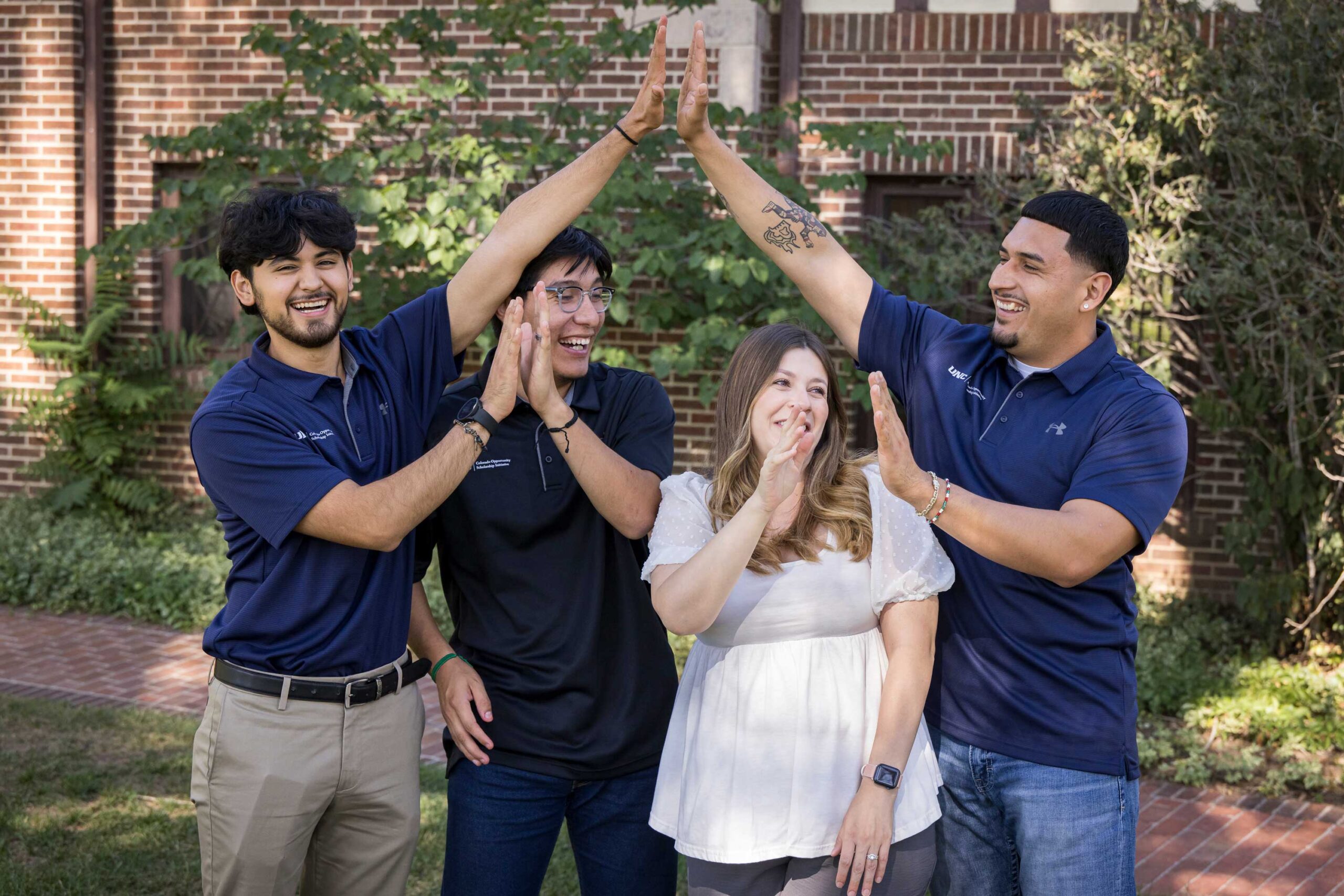 The COSI Group staff smile and high-five each other in a joyful, celebratory moment