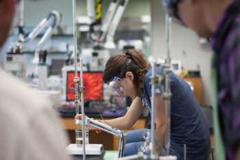 Chemistry measuring liquid contents in Chemistry lab.